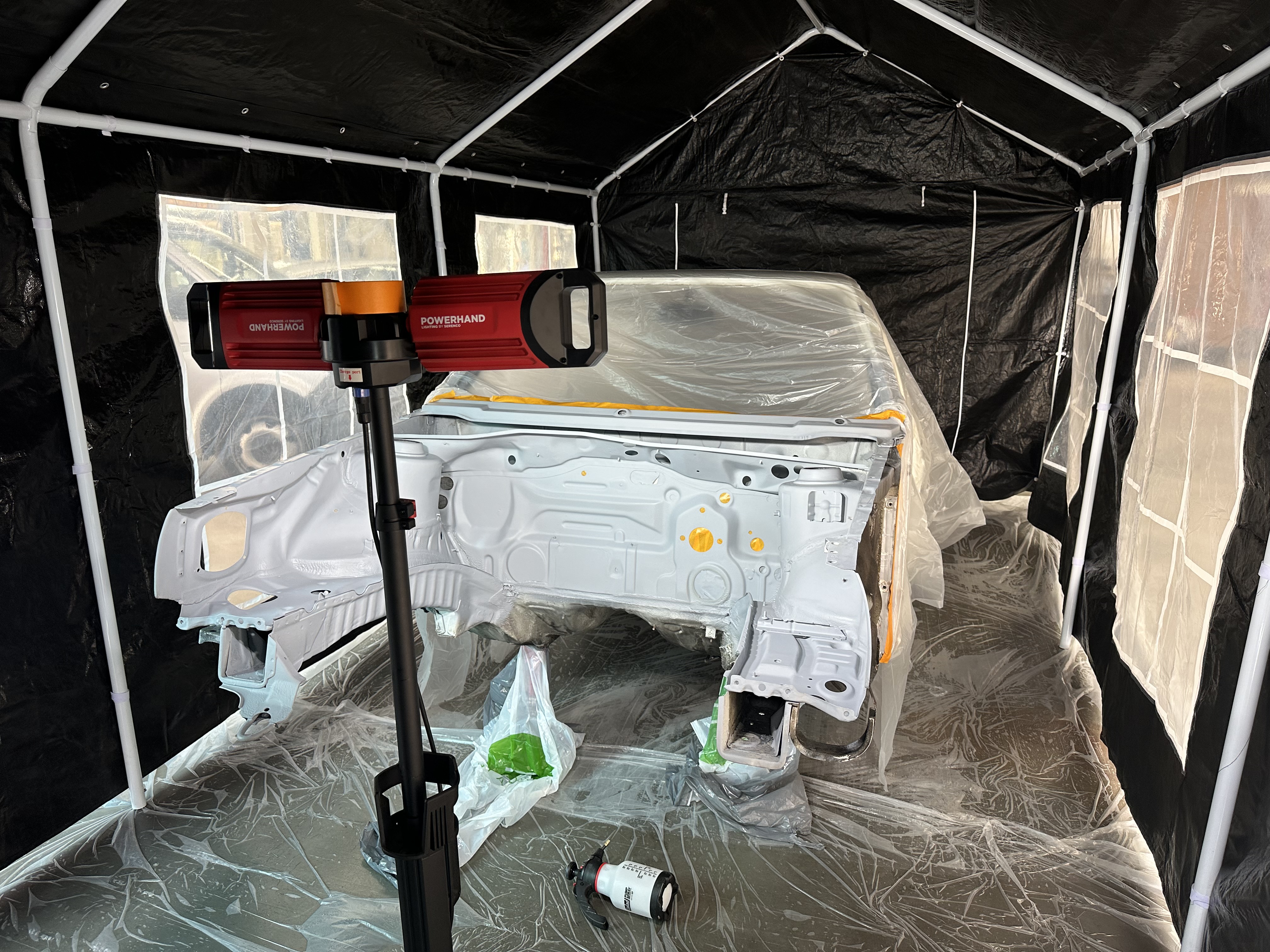 Golf shell primed in paint tent